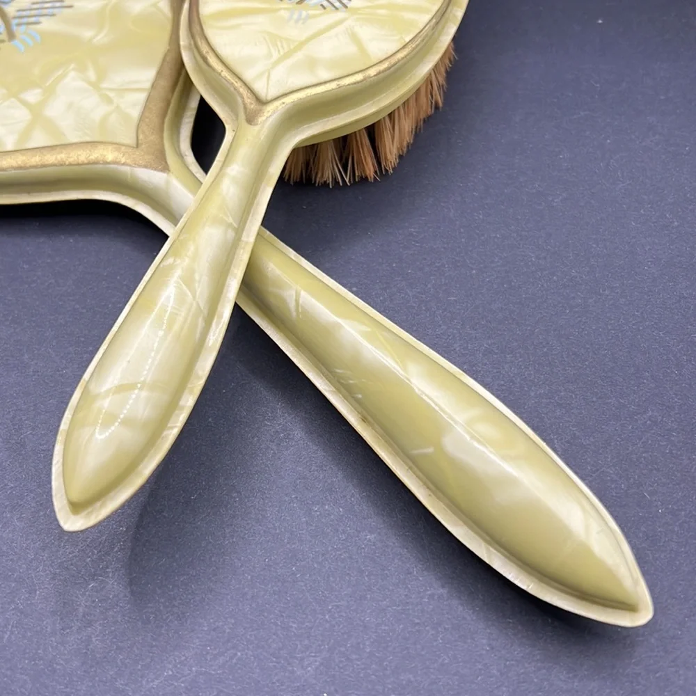 Vintage yellow celluloid vanity mirror, comb and brush set